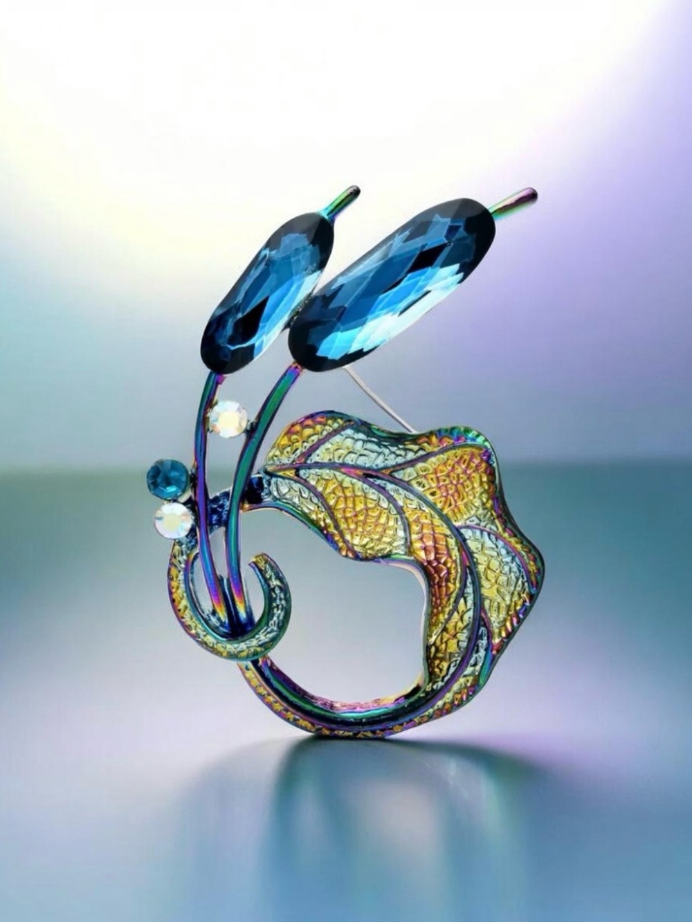 Iridescent Leaf Brooch with Deep Blue Faceted Stones